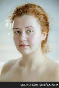 Closeup portrait of a young adult attractive woman with red hair without makeup. Art toning. Soft focus. Neutral background.. Closeup portrait of a young adult attractive woman with red hair without makeup. Art toning.