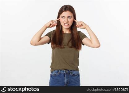 Closeup portrait of a young angry woman covering her ears, stop making that loud noise it&rsquo;s giving me a headache, isolated on white background. Closeup portrait of a young angry woman covering her ears, stop making that loud noise it&rsquo;s giving me a headache, isolated on white background.
