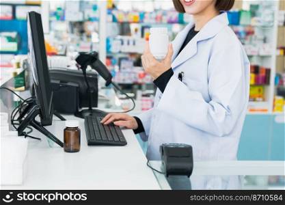 Closeup portrait of a young pharmacist and qualified pharmaceutical, medicine pill container or bottle mockup for copyspace at pharmacy. Drugstore concept with various medicine pills on. Closeup portrait of young asian pharmacist pill bottle at qualified pharmacy.