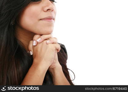 Closeup portrait of a young woman praying