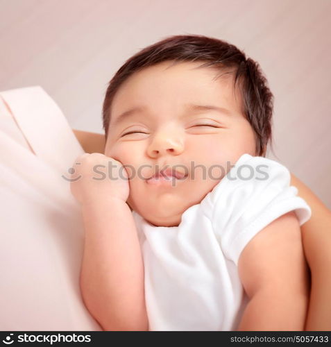 Closeup portrait of adorable Arabic child sleeping on mothers hands, little innocent baby, peace and harmony concept