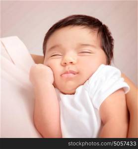 Closeup portrait of adorable Arabic child sleeping on mothers hands, little innocent baby, peace and harmony concept