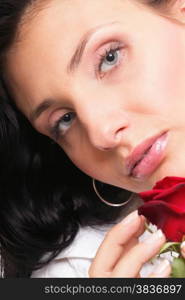 Closeup portrait of an attractive young woman holding a red rose