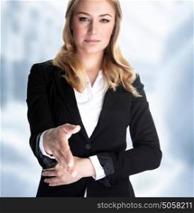Closeup portrait of attractive business woman stretches out her hand for a handshake with partner, make a bargain, successful career concept