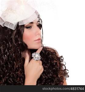 Closeup portrait of attractive female with dark curly hair isolated on white background, bridal look, hat with veil, luxury ring, fashion concept