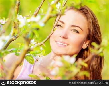 Closeup portrait of attractive young lady having fun outdoors, spring nature, apple tree blossom, sunny day, happiness concept&#xA;