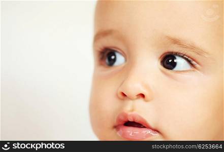 Closeup portrait of beautiful baby face over white background
