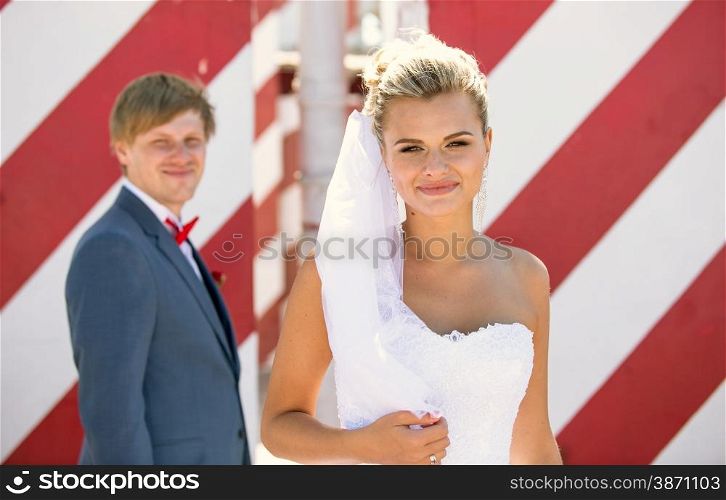 Closeup portrait of beautiful blonde bride posing on roof top
