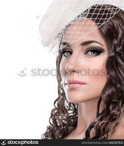 Closeup portrait of beautiful bride isolated on white background, gorgeous model wearing stylish hat with gentle veil, retro bridal look concept