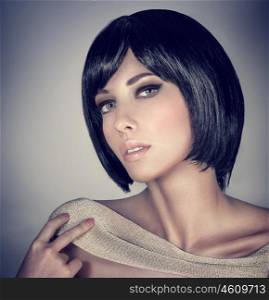 Closeup portrait of beautiful brunette female with stylish short haircut and makeup isolated on gray background, fashion and beauty concept