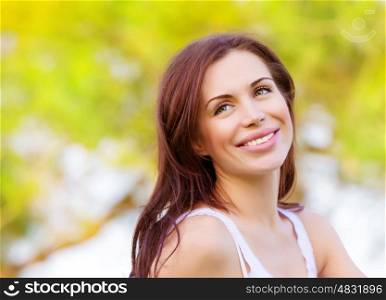 Closeup portrait of beautiful brunette woman in spring park, having fun outdoors, freedom and happiness concept