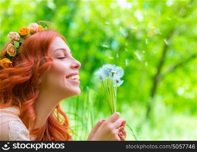 Closeup portrait of beautiful cheerful female holding in hands dandelion flowers and closed eyes of pleasure, enjoying beauty of spring nature