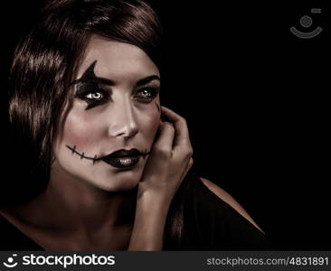 Closeup portrait of beautiful female with aggresive makeup for Halloween party, scary autumnal party celebration, mystery concept