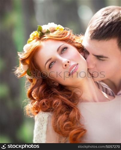 Closeup portrait of beautiful gentle loving couple, happy handsome groom kissing his lovely bride neck, love and romance concept