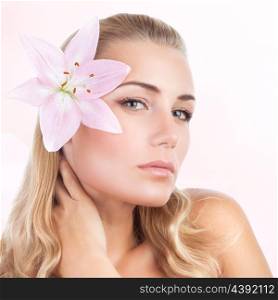 Closeup portrait of beautiful gentle woman with lily flower over pink background, natural beauty treatment, aroma therapy&#xA;
