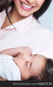 Closeup portrait of beautiful sleeping baby on mothers hands, enjoying motherhood, young happy family, love concept