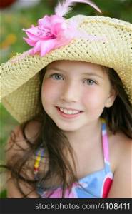 Closeup portrait of beautiful teen little girl with hat in the park