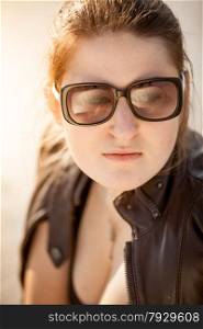 Closeup portrait of beautiful woman in sunglasses at desert