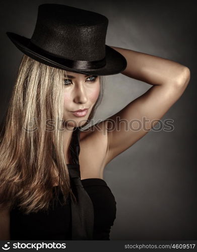 Closeup portrait of beautiful woman wearing stylish accessories isolated on gray background, black hat and tie, vintage style, fashion and vogue concept