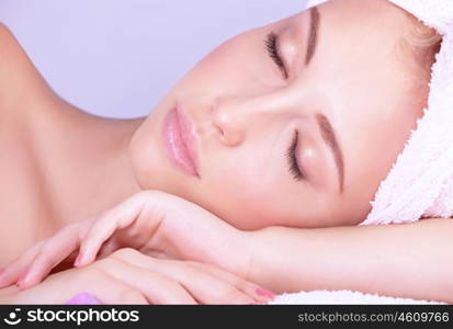 Closeup portrait of beautiful woman with closed eyes lying down on massage table, enjoying day spa, healthy lifestyle, medical beauty salon
