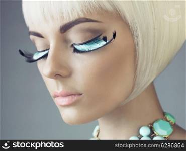 Closeup portrait of beautiful woman with color eyelashes