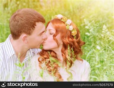 Closeup portrait of beautiful young couple kissing outdoors, spending wedding day in the park, sunny day, love and romance concept