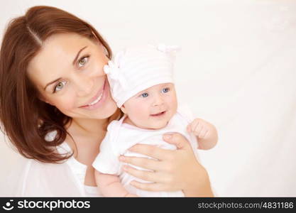 Closeup portrait of beautiful young mother carry cute little baby girl, at home, healthy childhood, new life concept