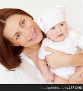 Closeup portrait of beautiful young mother carry little baby, at home, healthy childhood, child's safety concept