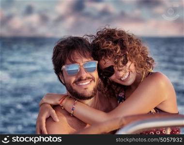 Closeup portrait of cheerful happy lovers on sailboat, young couple having fun in romantic sea traveling, love concept