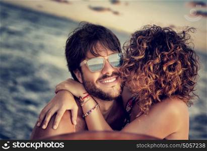 Closeup portrait of cheerful happy lovers on sailboat, young couple kissing and having fun in romantic cruise, love and enjoyment, summer vacation and holidays