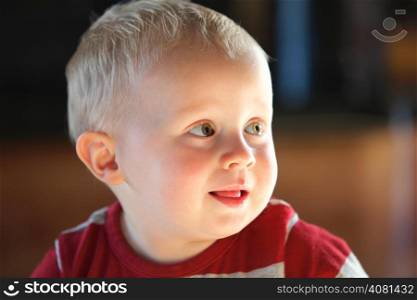 Closeup portrait of cheerful little boy smiling indoor