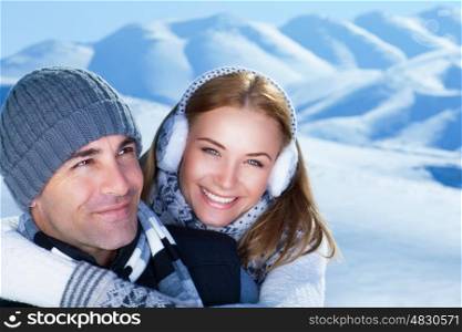 Closeup portrait of cheerful smiling couple in the winter park, having fun in the mountains, happy wintertime holidays