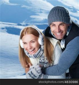 Closeup portrait of cheerful smiling couple playing with each other in the winter park, having fun in the mountains, happy wintertime holidays