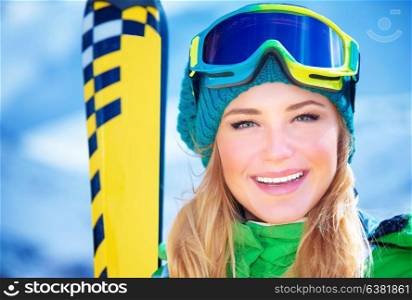 Closeup portrait of cheerful smiling girl wearing sportive equipment, active female enjoying ski sport, happy winter vacation concept