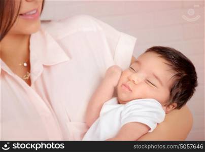 Closeup portrait of cute arabic newborn baby on mothers hands, happy young family, innocent child, new life concept