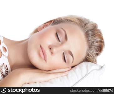 Closeup portrait of cute blond serene girl sleeping, attractive gentle female with closed eyes lying down on the pillow isolated on white background, peace and harmony concept