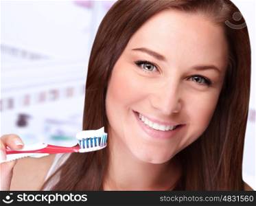 Closeup portrait of cute girl cleaning teeth at home, dental care, morning in bathroom, whiten toothpaste, freshness and beauty concept