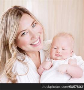 Closeup portrait of cute happy mommy holding on hands nice sleeping baby, day dreams, loving family, happiness concept