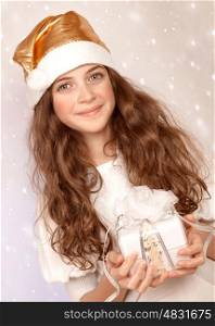 Closeup portrait of cute little Santa helper, sweet teen girl with white wrapping gift box on pink snowing background