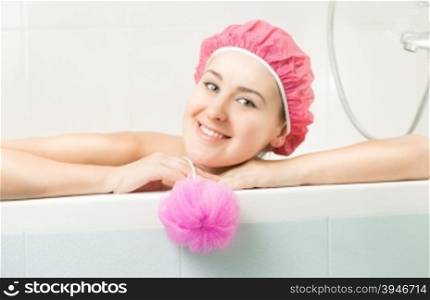 Closeup portrait of cute smiling woman posing in bath