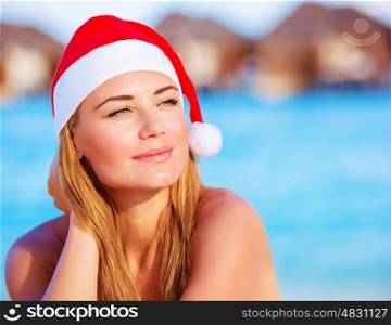 Closeup portrait of cute woman wearing red Santa hat, celebrating Christmas holidays on Maldive islands, New Year party on the beach
