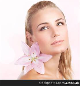 Closeup portrait of gentle cute female with pink lily flower in hair isolated on white background, aroma therapy, beauty treatment, apply natural cosmetics