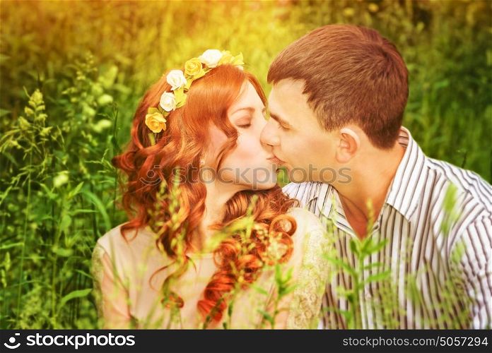 Closeup portrait of gentle young couple kissing outdoors, spending wedding day in the park, romantic date, love concept