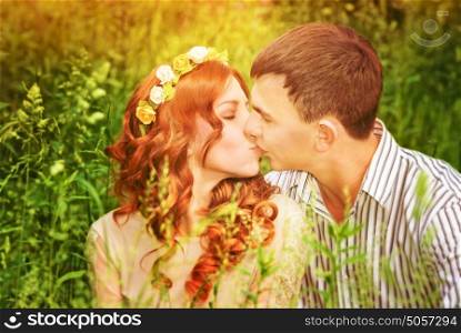Closeup portrait of gentle young couple kissing outdoors, spending wedding day in the park, romantic date, love concept