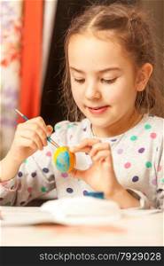 Closeup portrait of girl painting easter eggs
