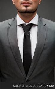 closeup portrait of handsome businessman on black
