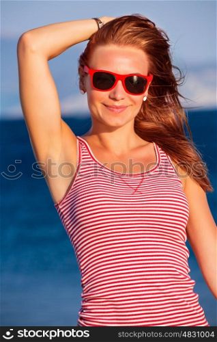 Closeup portrait of happy beautiful woman wearing stylish sunglasses, retro style look, enjoying sea, sunny day, summer vacation