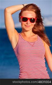 Closeup portrait of happy beautiful woman wearing stylish sunglasses, retro style look, enjoying sea, sunny day, summer vacation