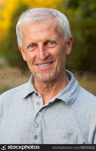 Closeup portrait of happy face of grey-haired old man. Outdoor