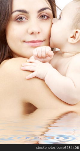 closeup portrait of happy mother with baby in water